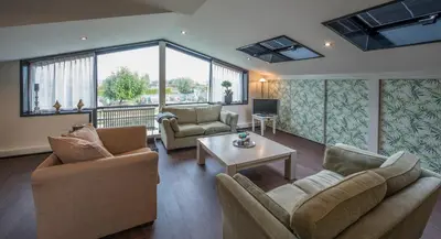 a living room with two couches and a table at Ghoyhuys in Leiderdorp