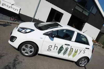 a small white car parked in front of a building at Ghoyhuys in Leiderdorp