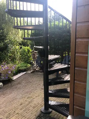 a spiral bird feeder sitting on a patio at Luxe Room Canal Sight in Amsterdam