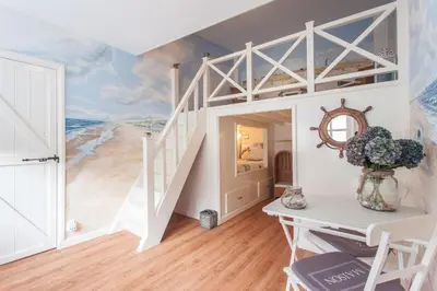 a room with a bunk bed with a beach mural at B&B 'De Bedstee' in Rijnsburg