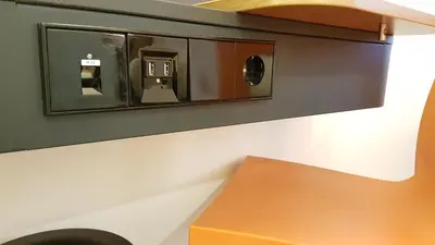 a lightswitch on a wall next to a bench at easyHotel Amsterdam Arena Boulevard in Amsterdam