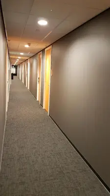 an empty hallway of an office building with a long aisle at easyHotel Amsterdam Arena Boulevard in Amsterdam