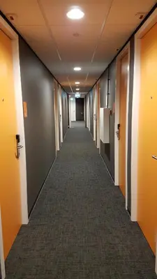 a hallway of an office building with a long corridor at easyHotel Amsterdam Arena Boulevard in Amsterdam