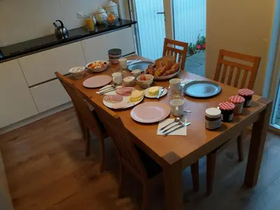 a wooden table with plates of food on it at Marbles Inn in Amsterdam
