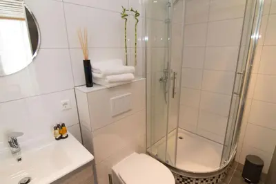 a bathroom with a shower and a toilet and a sink at Marbles Inn in Amsterdam