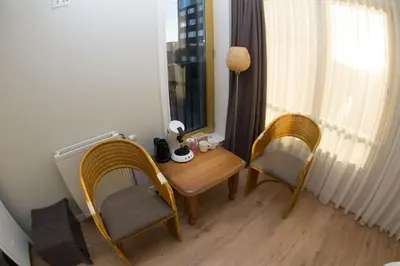 a room with a table and chairs and a window at Marbles Inn in Amsterdam
