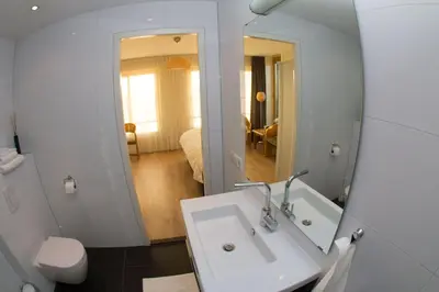 a bathroom with a white sink and a mirror at Marbles Inn in Amsterdam