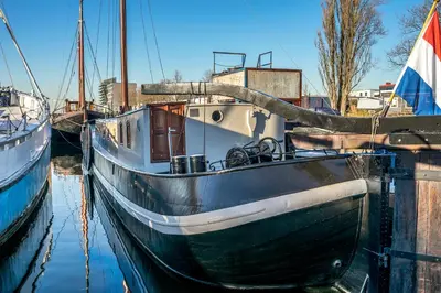 a boat is docked in a marina at Asile Flottant in Amsterdam