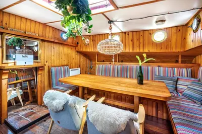 a dining room with a wooden table and chairs at Asile Flottant in Amsterdam