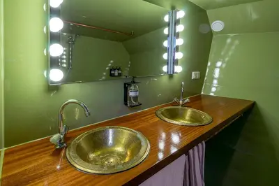 a bathroom with two sinks and a large mirror at Asile Flottant in Amsterdam
