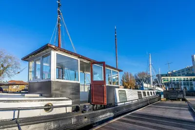 a boat is docked at a dock at Asile Flottant in Amsterdam