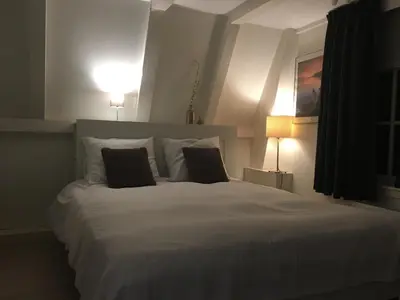 a bedroom with a large white bed with two pillows at Nine Streets Inn in Amsterdam