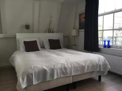 a white bed with two pillows in a bedroom at Nine Streets Inn in Amsterdam