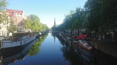 a river with boats parked on the side of it at Nine Streets Inn in Amsterdam