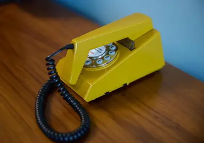 a yellow phone sitting on top of a table at The July - Twenty Eight in Amsterdam