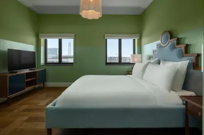 a bedroom with a large bed and a flat screen tv at The July - Twenty Eight in Amsterdam