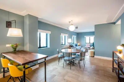 a living room with blue walls and a table and chairs at The July - Twenty Eight in Amsterdam