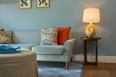 a living room with a couch and a lamp at The July - Twenty Eight in Amsterdam