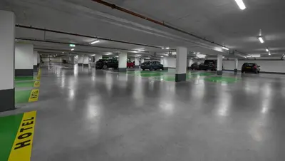 an empty parking garage with cars parked in it at The July - Twenty Eight in Amsterdam