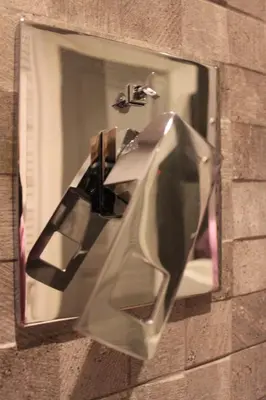 a mirror on the side of a brick wall at Former Rembrandt workshop two bedroom B&B in Amsterdam