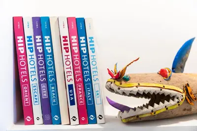 a group of books on a shelf with a dinosaur toy at Former Rembrandt workshop two bedroom B&B in Amsterdam
