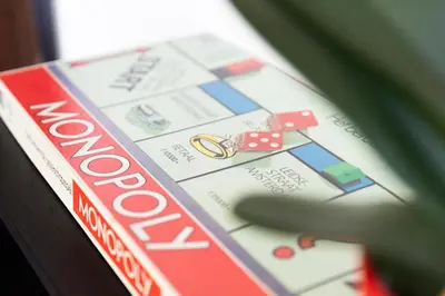 a remote control sitting on top of a monopoly game at Former Rembrandt workshop two bedroom B&B in Amsterdam