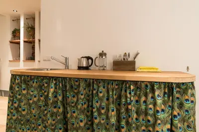 a kitchen with a counter top with peacocks on it at Saint Claire Studio in Amsterdam