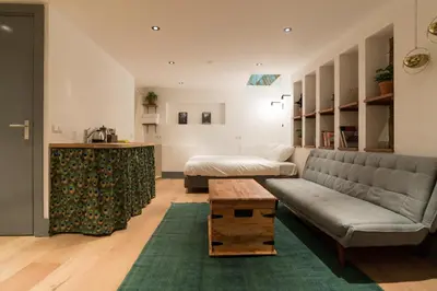 a living room with a couch and a table at Saint Claire Studio in Amsterdam