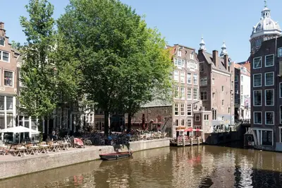 a canal in a city with buildings next to a river at Saint Claire Studio in Amsterdam