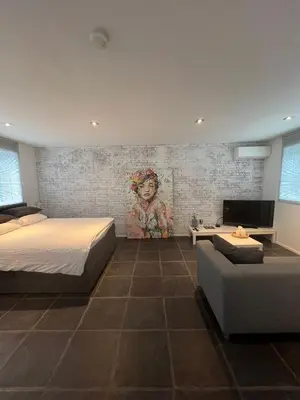 a bedroom with a bed and a couch at B&B Sloterpark in Amsterdam