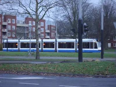 a blue and white train on a city street at B&B Sloterpark in Amsterdam