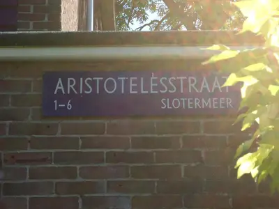 a street sign on a brick wall at B&B Sloterpark in Amsterdam