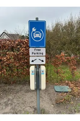 a free parking sign with arrows on a pole at Holiday Home Alk 8-1 by Interhome in Noordwijkerhout