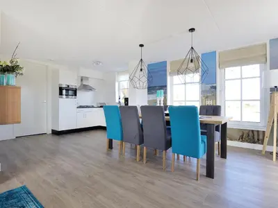 a kitchen and dining room with a table and chairs at Holiday Home Tapuit 8-1 by Interhome in Noordwijk
