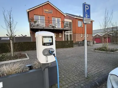 a parking meter on the side of a street at Holiday Home Dorregeest-1 by Interhome in Uitgeest