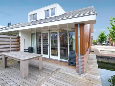 a house with a picnic table on a deck at Holiday Home Dorregeest-1 by Interhome in Uitgeest
