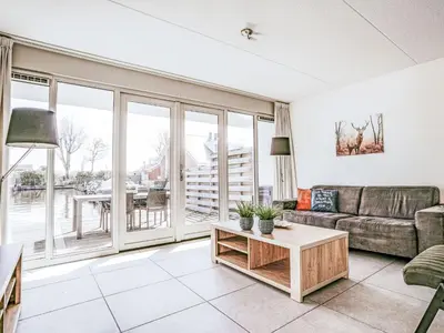 a living room with a couch and a table at Holiday Home Dorregeest-1 by Interhome in Uitgeest