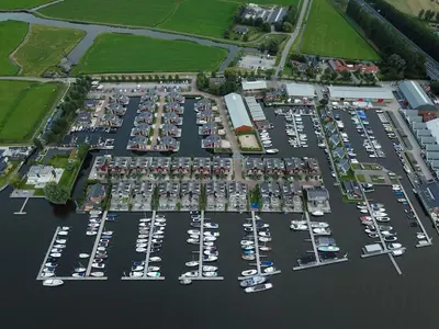 an aerial view of a parking lot with boats at Holiday Home De Woude by Interhome in Uitgeest