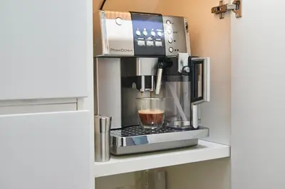 a coffee maker sitting on a shelf in a kitchen at Luxurious 110m² 3br Houseboat in Amsterdam Centre! in Amsterdam