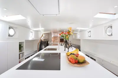 a kitchen with a bowl of fruit on a counter at Luxurious 110m² 3br Houseboat in Amsterdam Centre! in Amsterdam