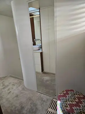 a mirror in a bathroom with a sink and a toilet at Luxurious 110m² 3br Houseboat in Amsterdam Centre! in Amsterdam