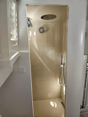 a shower with a glass door in a bathroom at Luxurious 110m² 3br Houseboat in Amsterdam Centre! in Amsterdam