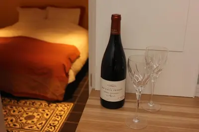 a bottle of wine and two wine glasses on a table at De Verrassing in Utrecht
