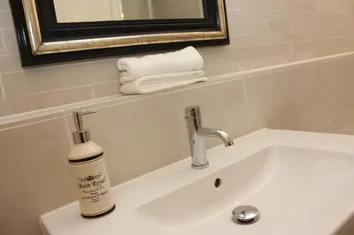 a bathroom sink with a bottle of soap on it at De Verrassing in Utrecht