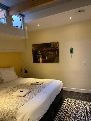 a bedroom with a bed with two towels on it at De Verrassing in Utrecht