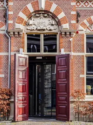 an entrance to a brick building with an open door at Boutiquehotel Staats in Haarlem