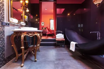 a bathroom with a sink and a mirror at Boutiquehotel Staats in Haarlem