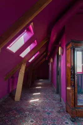 a hallway with purple walls and a ceiling with lights at Boutiquehotel Staats in Haarlem