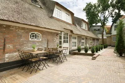 a patio with tables and chairs in front of a building at 