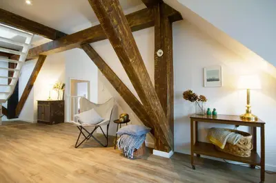 a room with wooden beams and a chair and a table at 